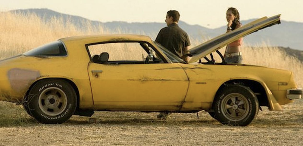A vintage yellow Chevy Camaro.