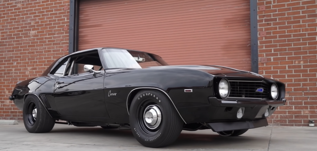 A black vintage Chevy Camaro.