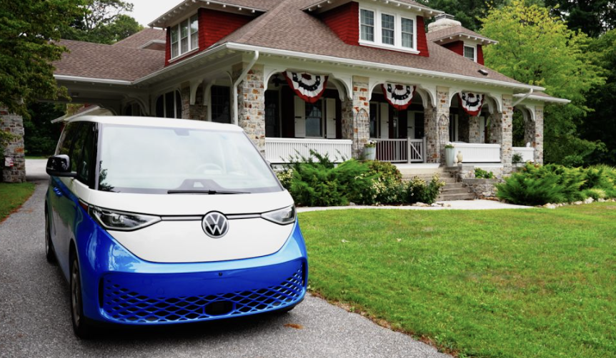A VW Microbus EV in front of a house.
